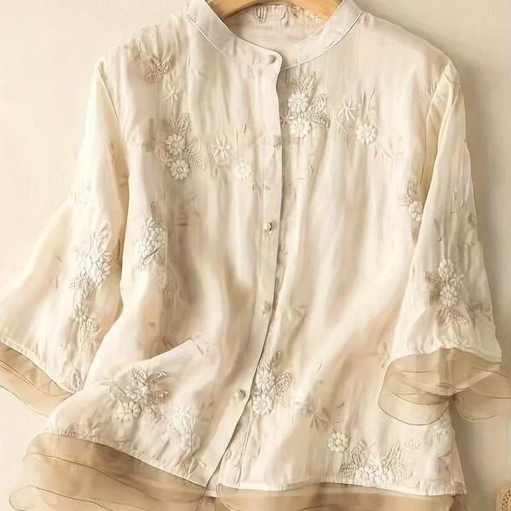 Elegant women's embroidered floral blouse with long sleeves & chic button closure, perfect for spring fashion.