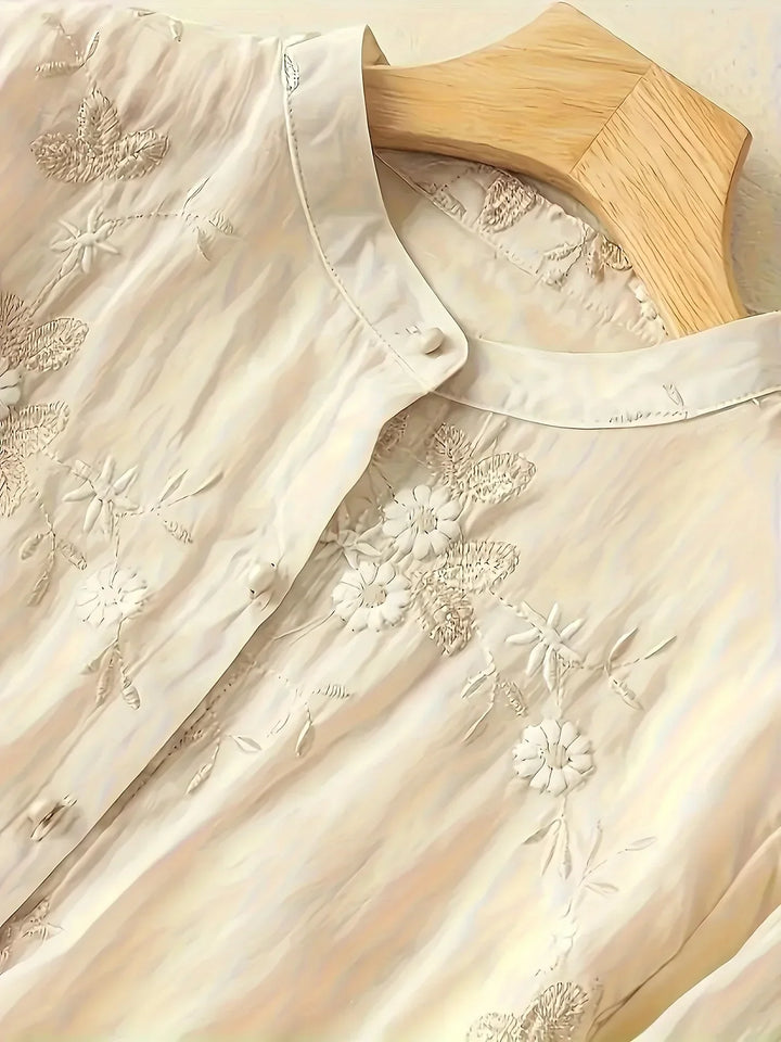 Elegant women's blouse, featuring delicate floral embroidery, button closure, and long sleeves for a polished look.