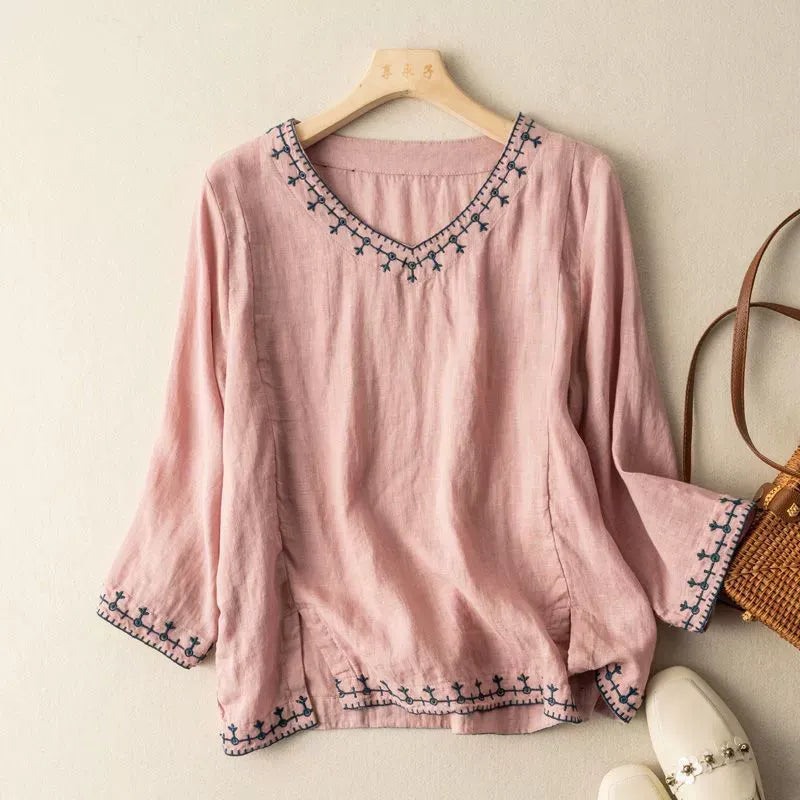 Stylish women's blouse with intricate embroidery and three-quarter sleeves, an elegant choice for daywear.