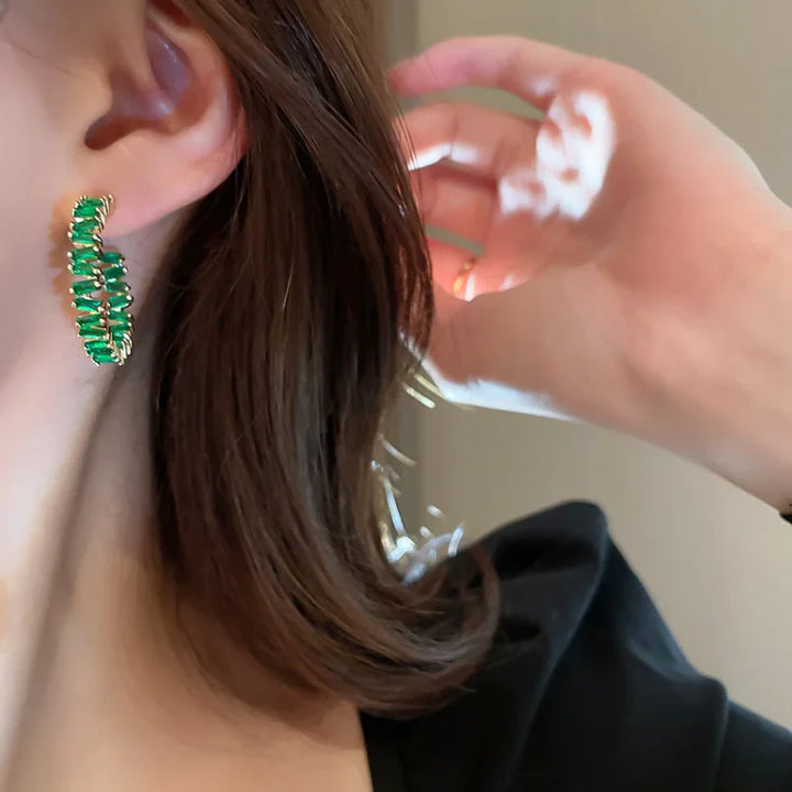 Elegant women's emerald green crystal hoop earrings, gold plated & sparkling, perfect fashion accessory.