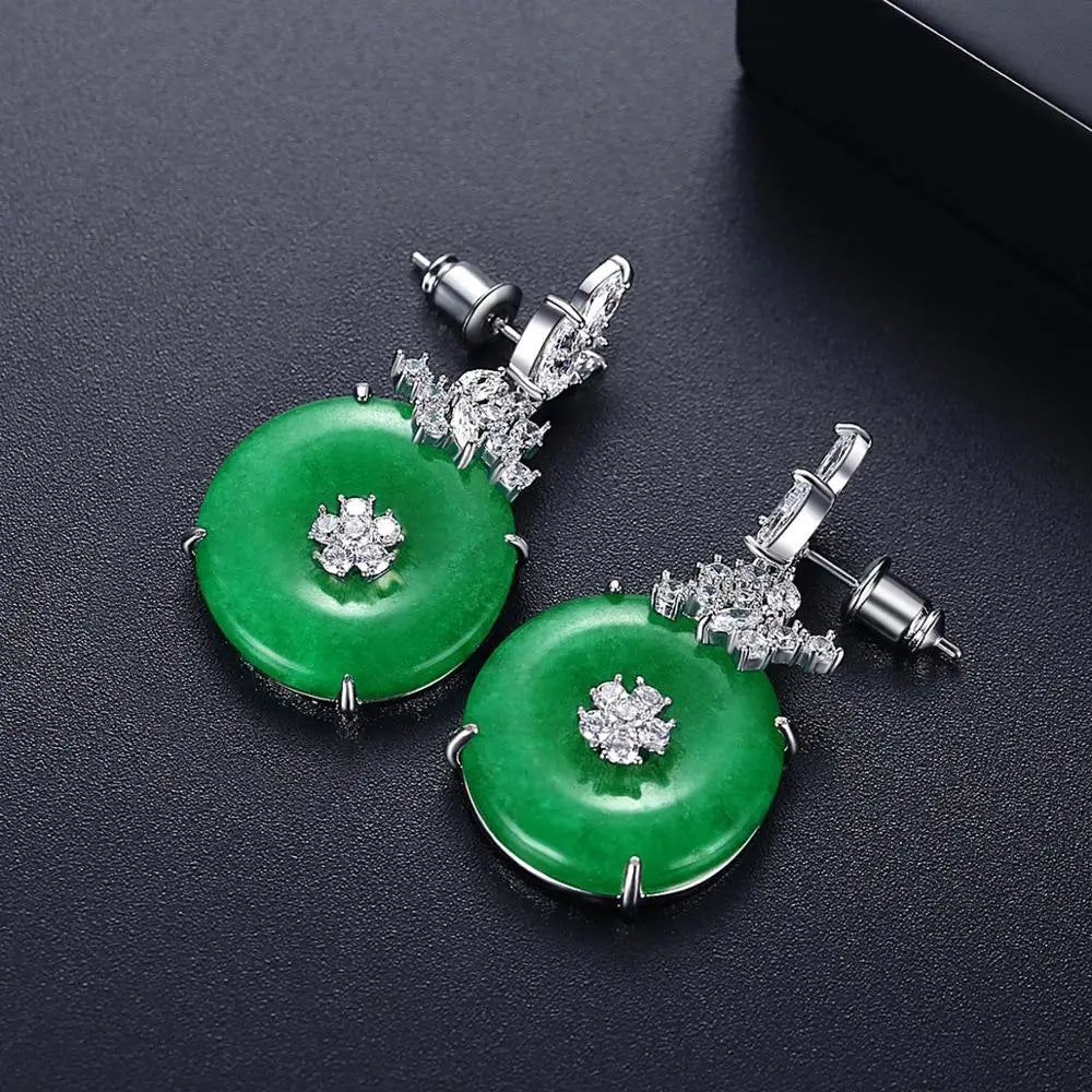 Timeless emerald green gemstone earrings for women, featuring brilliant green stones set in polished stainless steel.
