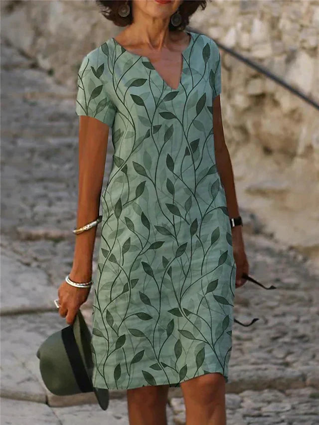 Elegant women's emerald green midi dress with V-neck and short sleeves, perfect for parties or summer events.