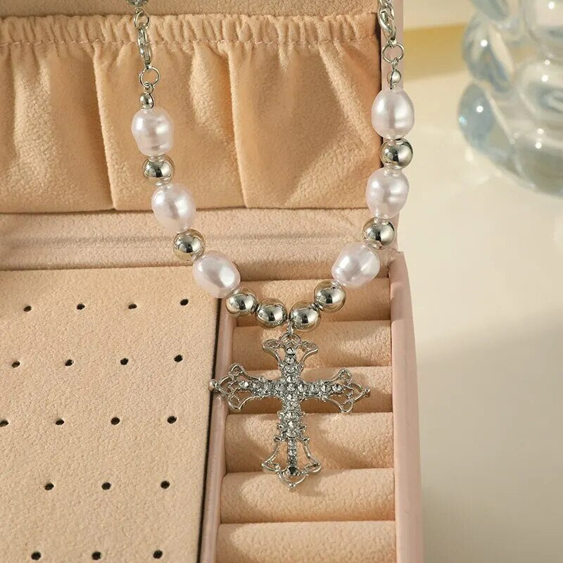 Women's elegant faux pearl cross pendant necklace, a versatile and dainty fashion accessory for daily wear or events.