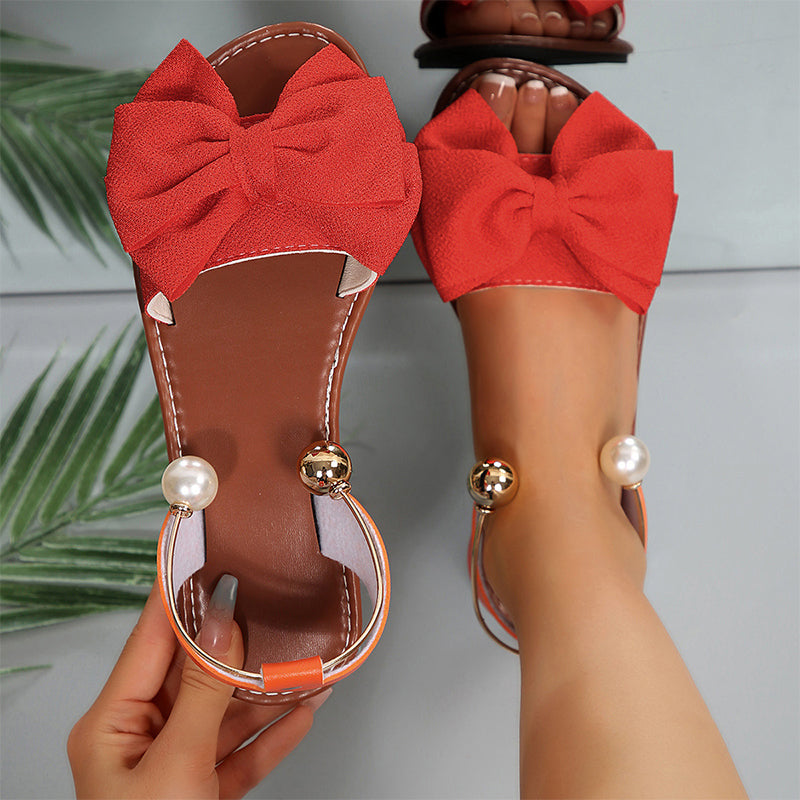 Fashionable women's summer flat sandals with an elegant bow & sparkling bead embellishments. Easy slip-on.