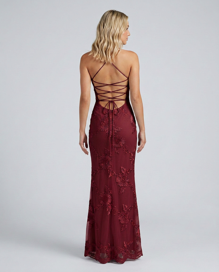 Formal women's maxi dress with exquisite floral appliqué details & alluring lace-up back.