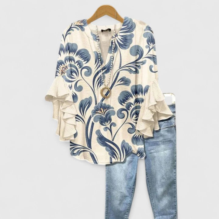 Elegant women's floral blouse with ruffled sleeves. Chic fashion for summer or dressy occasions.