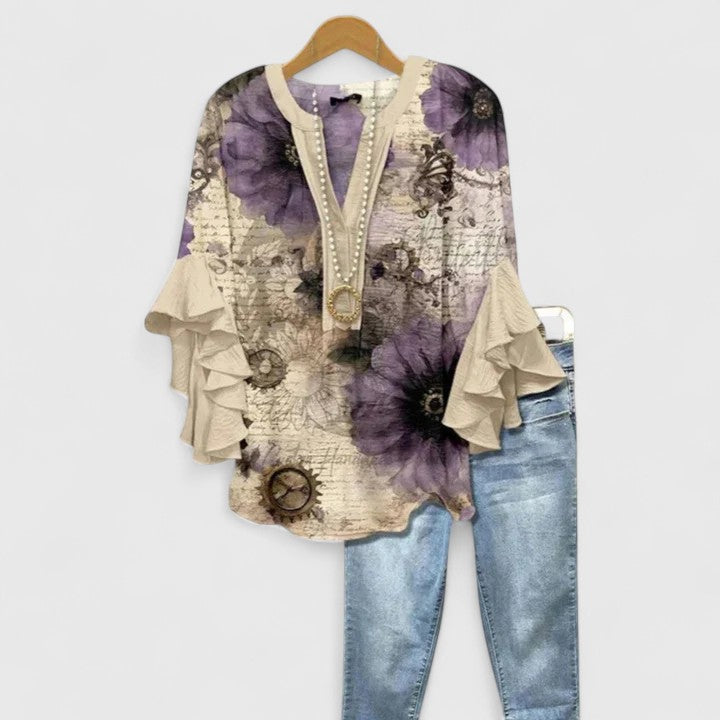 Stylish women's floral blouse with chic ruffles. Versatile top for elegant summer fashion or dressy wear.