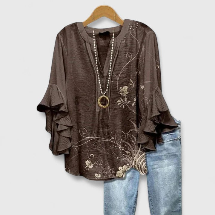 Stylish women's floral blouse, perfect for summer. Casual yet dressy with chic ruffled sleeves.