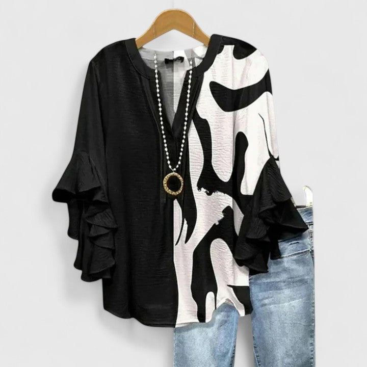 Versatile women's floral top, elegant design. Long-sleeve blouse with chic ruffles for any occasion.