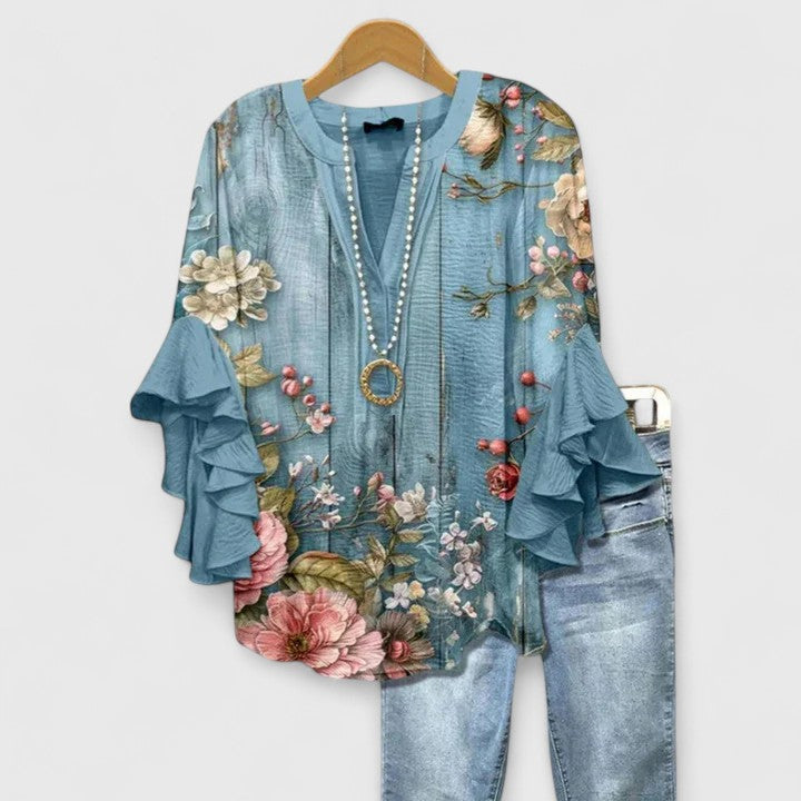 Pretty women's floral blouse with elegant ruffles. Chic summer style, perfect as a dressy or casual top.