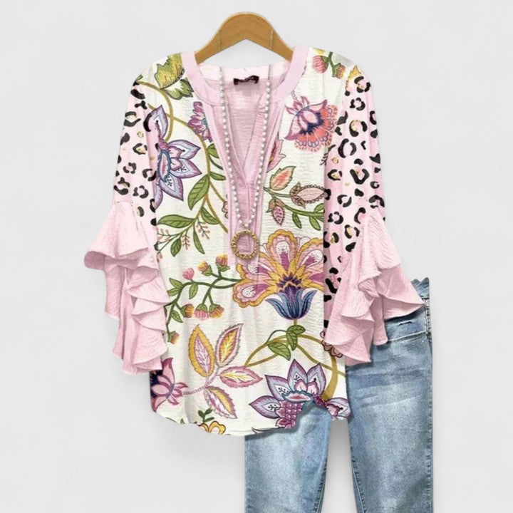 Chic women's blouse with vibrant floral print. Ruffled sleeves add elegance, versatile for summer style.