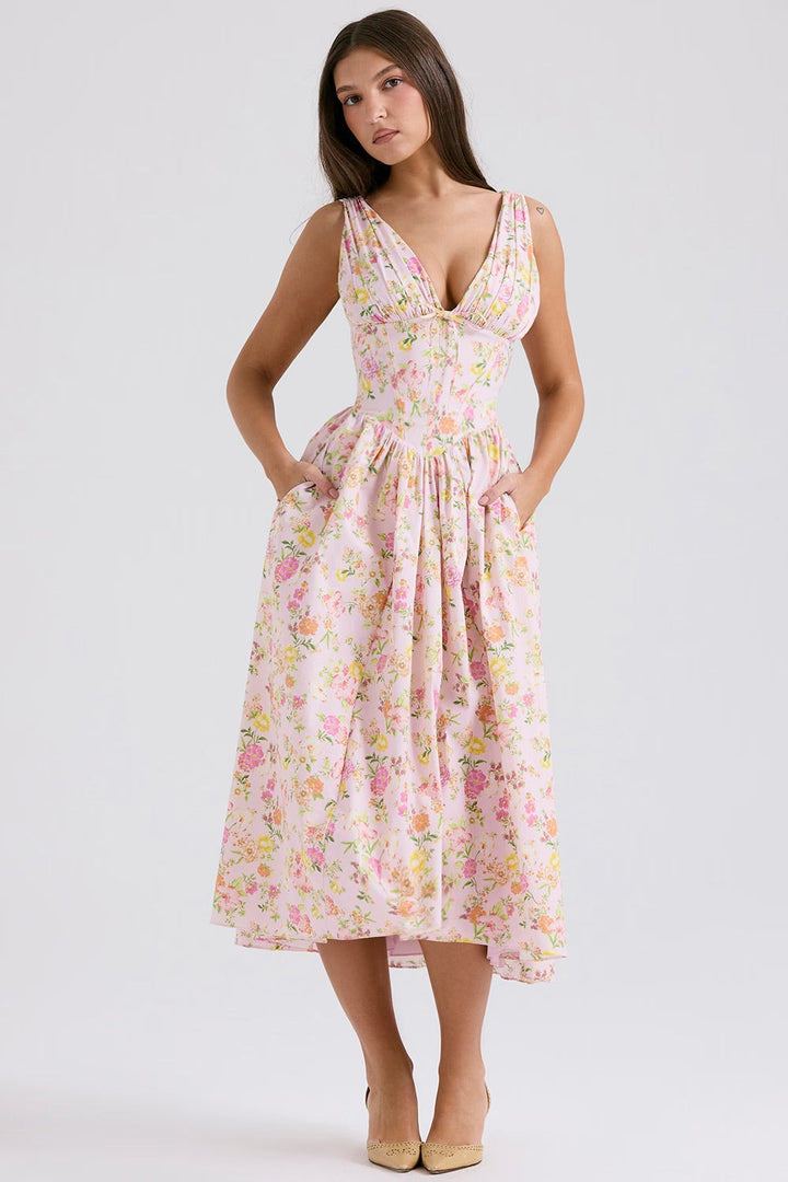Vibrant floral midi dress with a corset bodice and V-neck, ideal for wedding guests & special occasions.