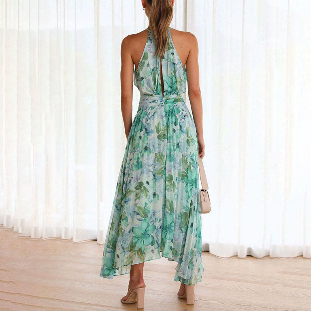 Stylish summer floral maxi dress for women, featuring a halter neck, pleated skirt & twist waist detail.