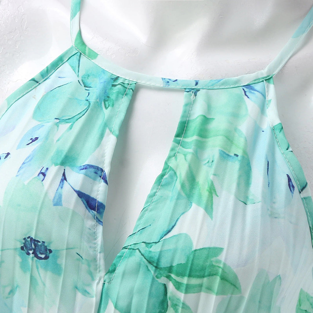 Chic women's pleated floral maxi dress with a sophisticated halter neckline, perfect for elegant gatherings.