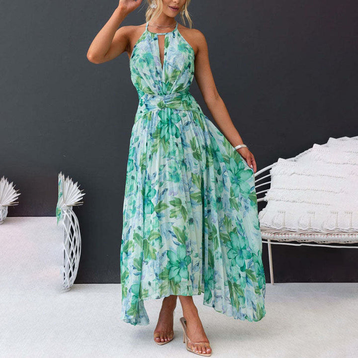 Women's elegant floral maxi dress with halter neck, pleated skirt, & flattering twist waist for summer weddings.