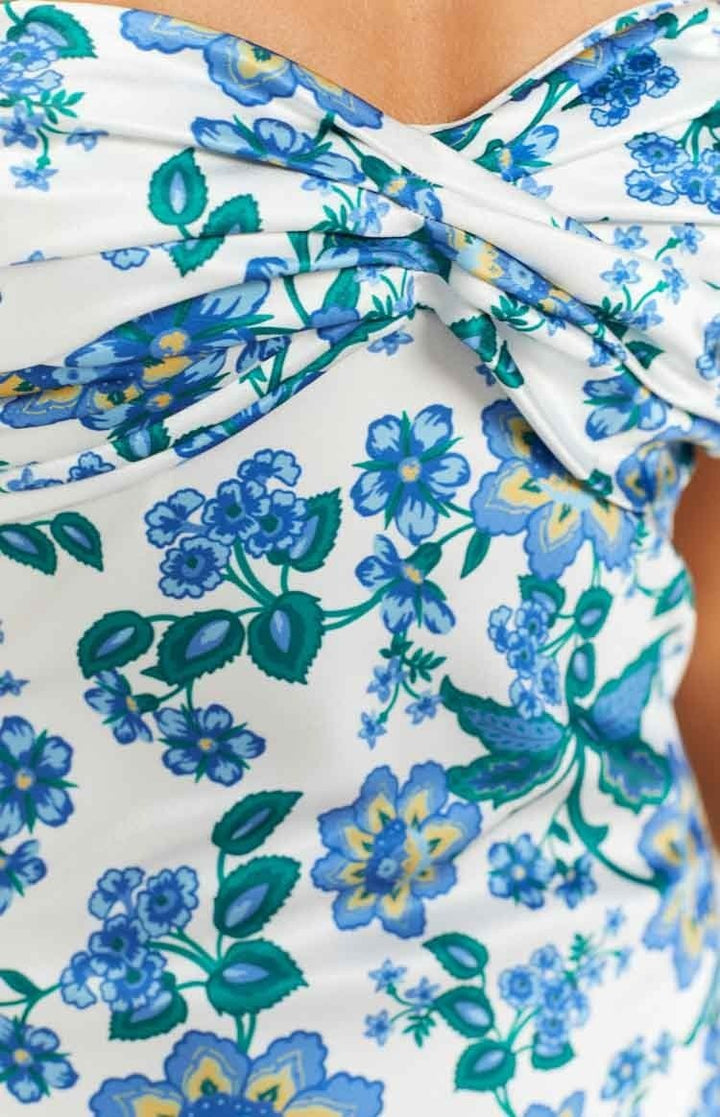 Full length view of women's knotted tube maxi dress with vibrant blue floral pattern.