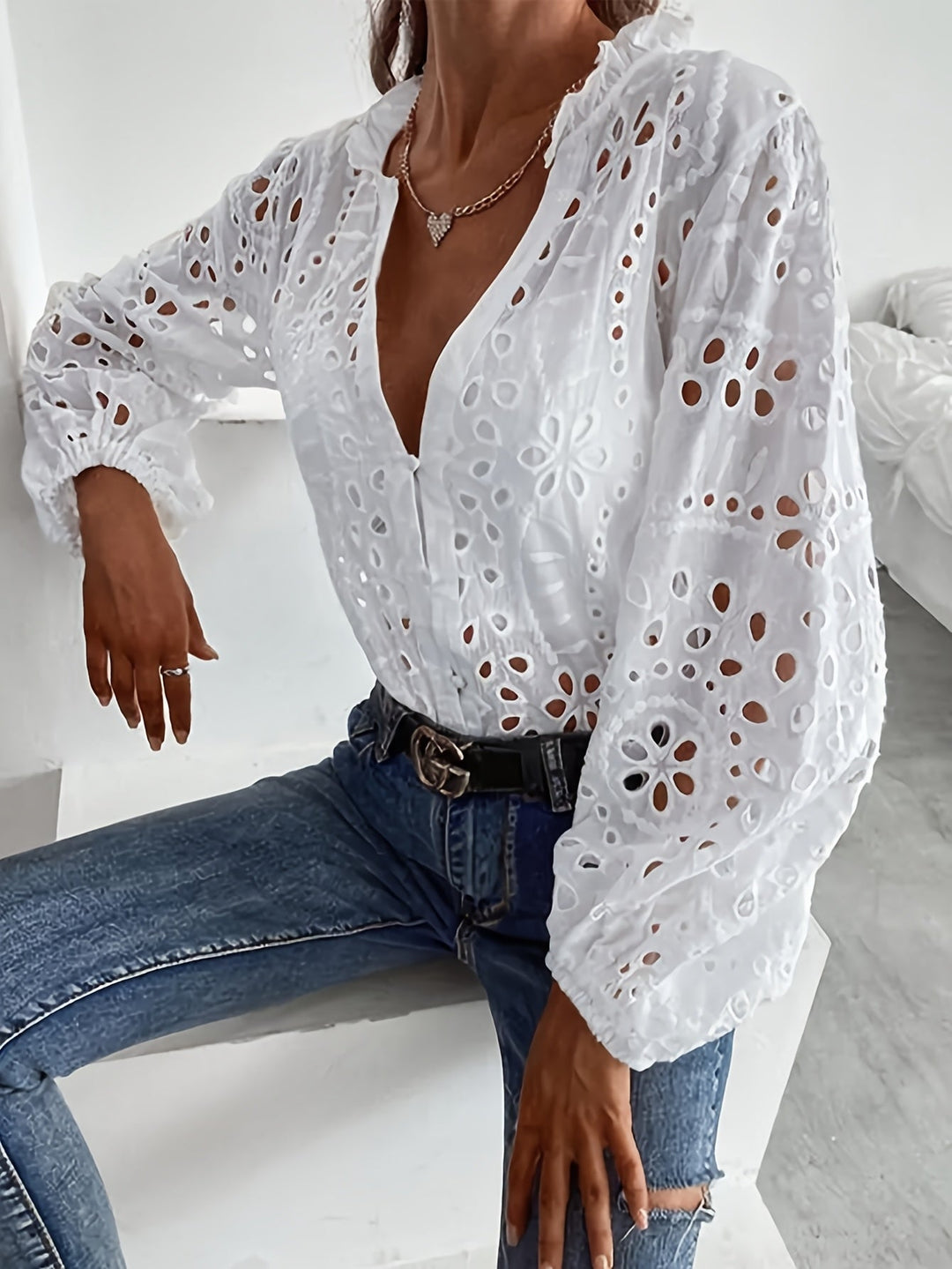 Women's fashion blouse: elegant floral embroidered long-sleeve top with button cuffs.