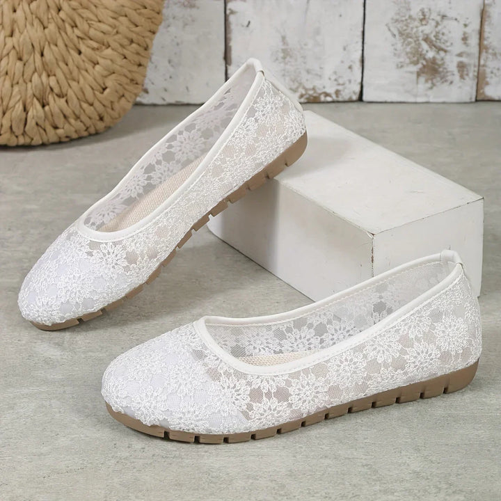 White floral pattern women's ballerinas. Comfortable slip-on flats for elegant casual wear and spring footwear.
