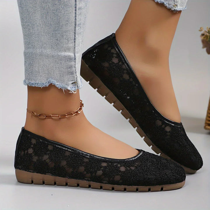 Close-up of elegant flower pattern on women's comfortable slip-on ballerinas. Stylish floral flats for spring.
