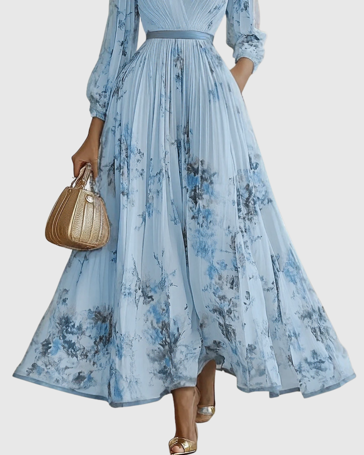 Close-up of elegant floral print on women's V-neck pleated maxi dress, ideal for special occasions.