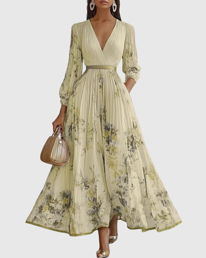 Detailed view of graceful pleats on a women's floral maxi evening dress, perfect for parties.