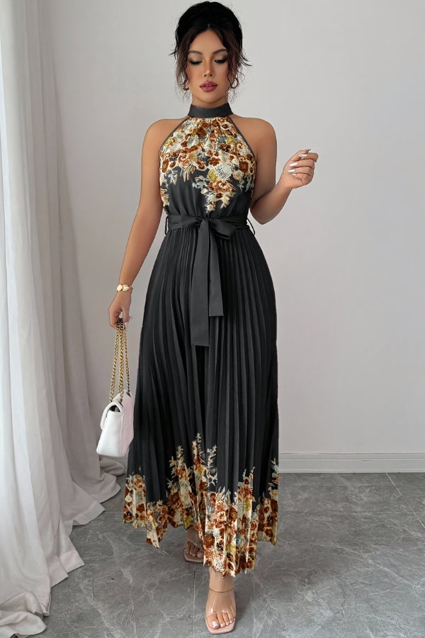 Detail of the elegant square neckline and floral print on a women's pleated midi dress.