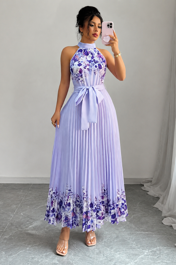 Side view of a women's floral pleated midi dress, showcasing its flowy silhouette and square neck.
