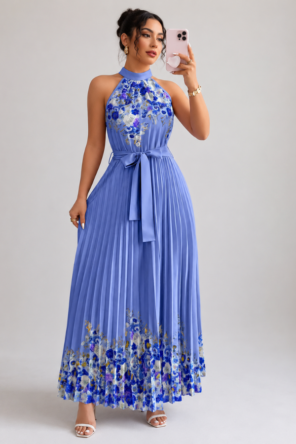 Woman wearing a floral pleated midi dress with a square neck, walking gracefully in a summer setting.