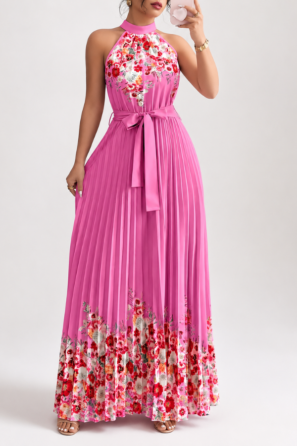 Women's floral pleated midi dress with square neck, styled with a sun hat for a chic vacation look.