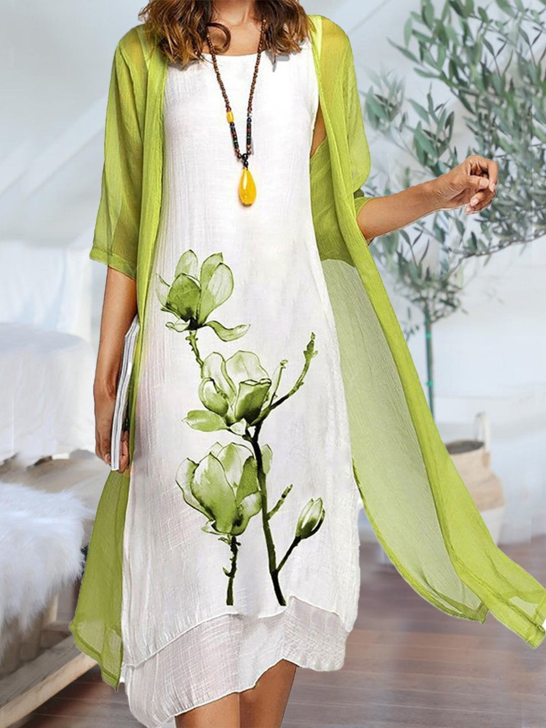 Elegant women's floral print midi dress and sheer cardigan matching set. Perfect two-piece layered style for spring/summer.