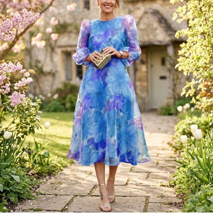 Close-up of a women's floral print midi dress fabric, showing vibrant pink and blue flowers, ideal for spring.