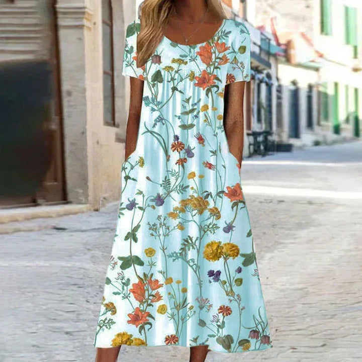 Relaxed fit women's short sleeve floral midi dress, ideal for warm weather, showcasing a feminine style.