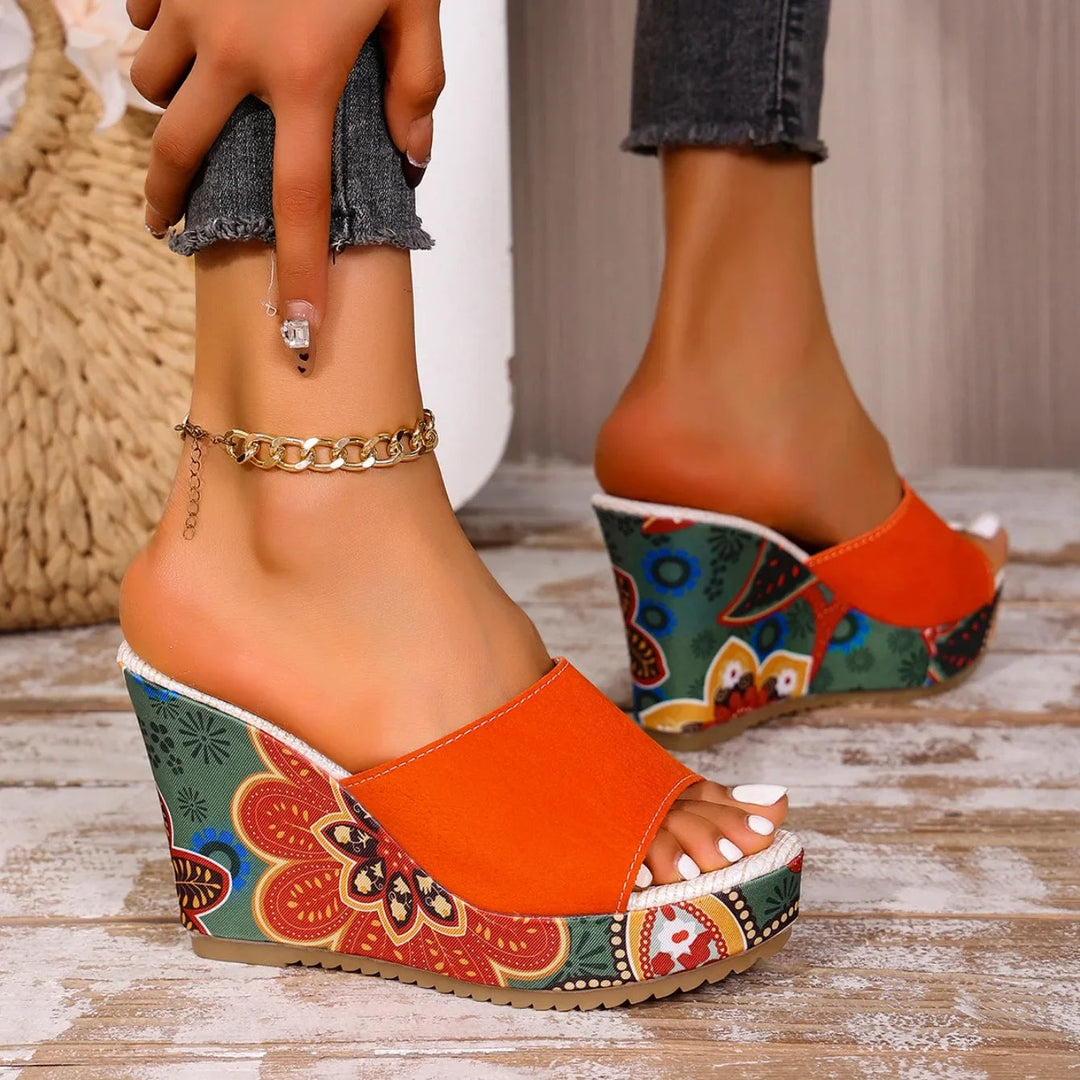 Artistic floral design on elegant women's slip-on wedge sandals, perfect for stylish summer fashion.