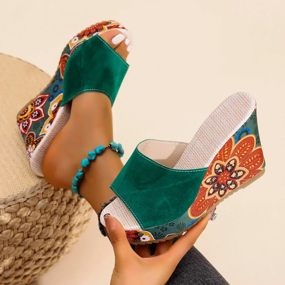 Stylish women's wedge sandals featuring a vibrant floral print and easy slip-on design.