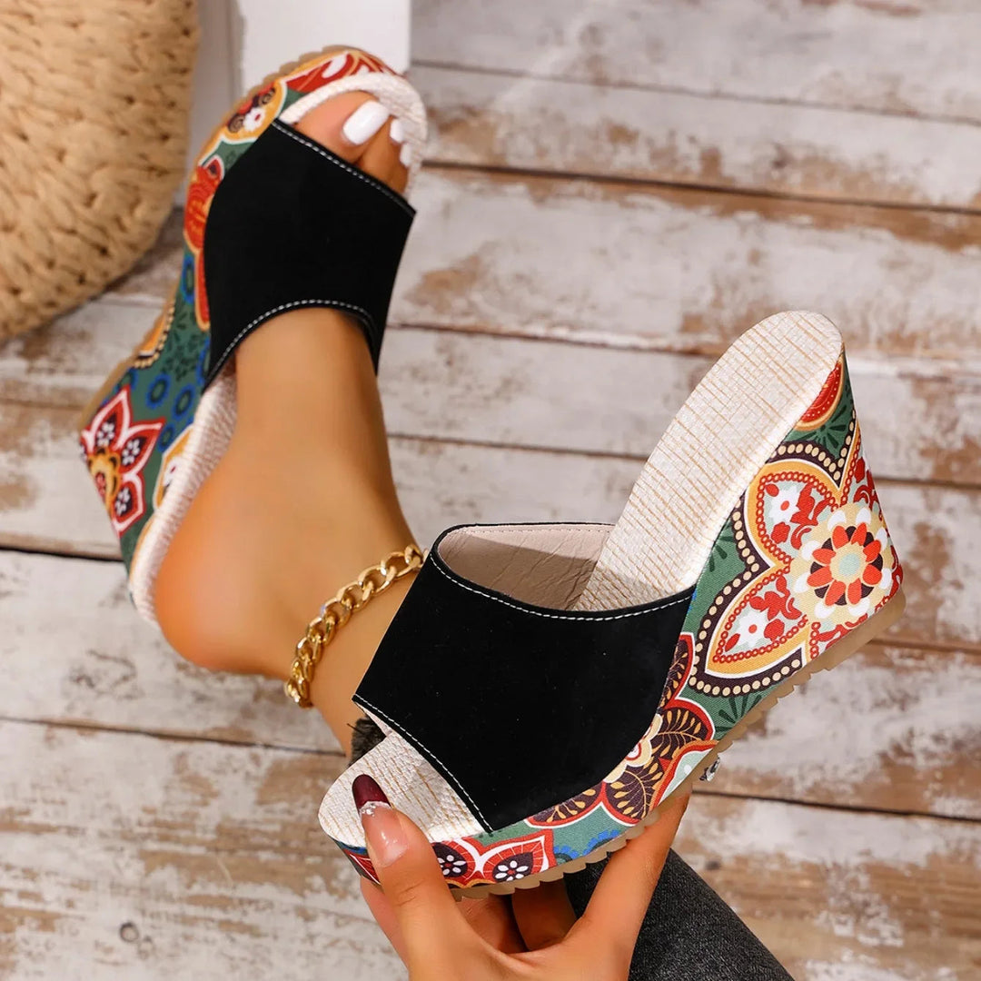 Lightweight women's slip-on wedge sandals with a vibrant floral pattern for summer style.