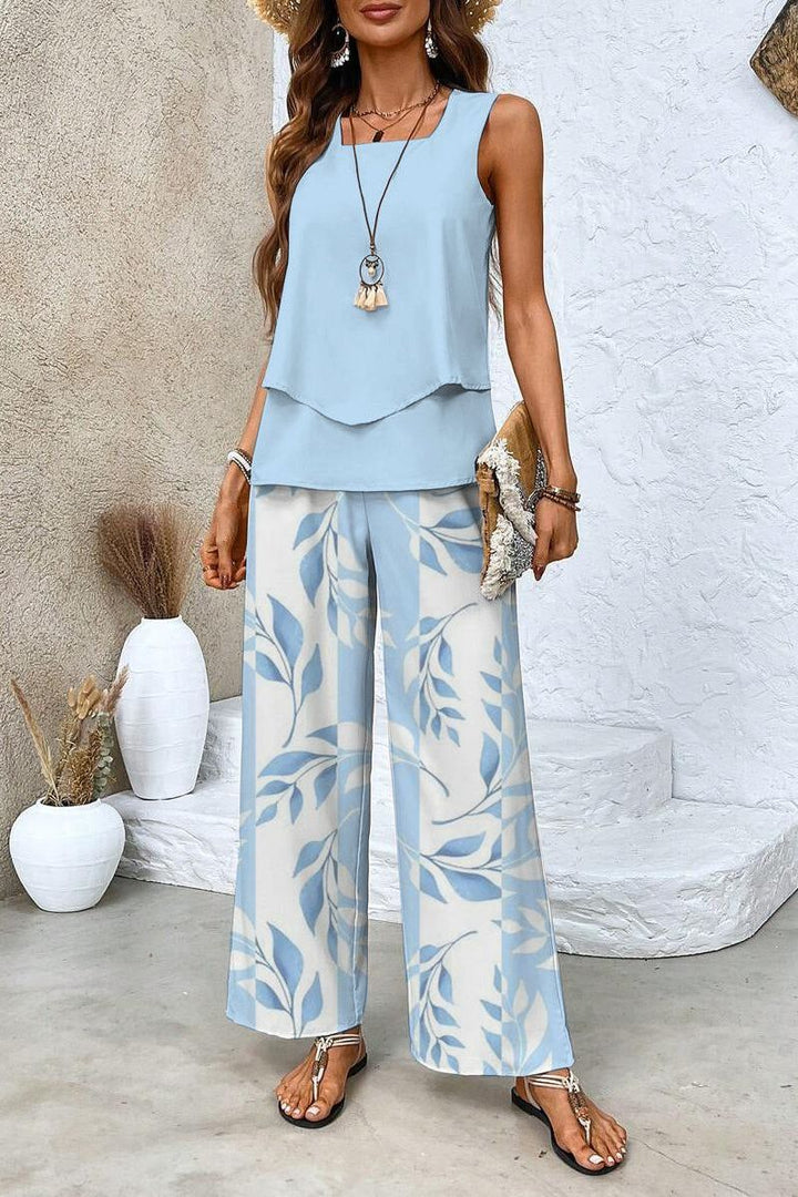 Elegant women's floral two-piece set, featuring a chic top & matching trousers for a fashionable, versatile outfit.