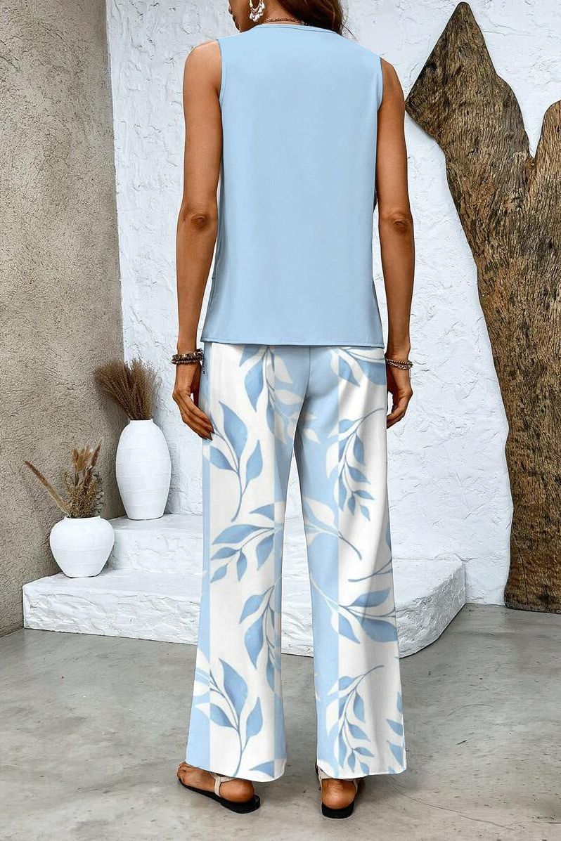 Fashionable women's floral top paired with elegant matching trousers, creating a versatile two-piece outfit.