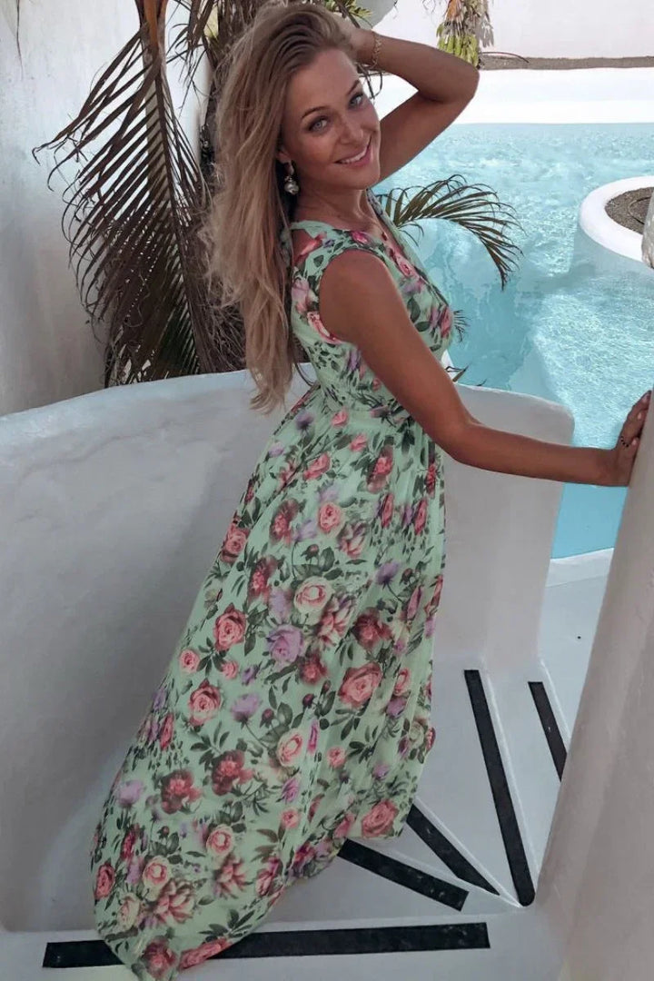 Women's elegant floral wrap maxi dress. Sleeveless, long design for summer, beach, or party. Vacation ready.
