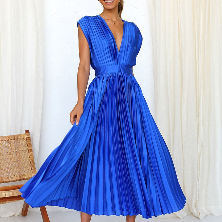 Sophisticated women's elegant flowing V-neck maxi dress with pleats, styled for an evening occasion.