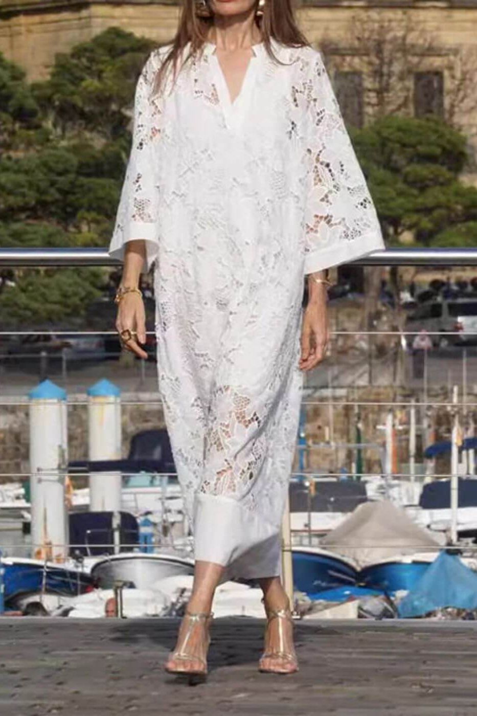 Relaxed fit women's long flowing white maxi dress. Comfortable event wear, versatile for formal or casual chic style.