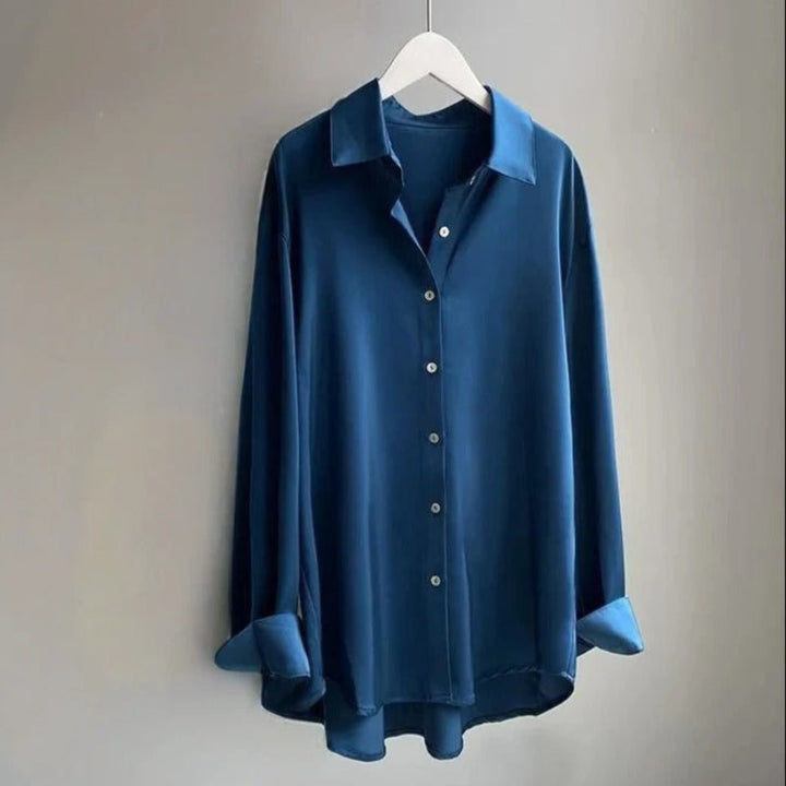 Women's white long sleeve flowy top, ideal for office attire or a casual chic spring fashion look.