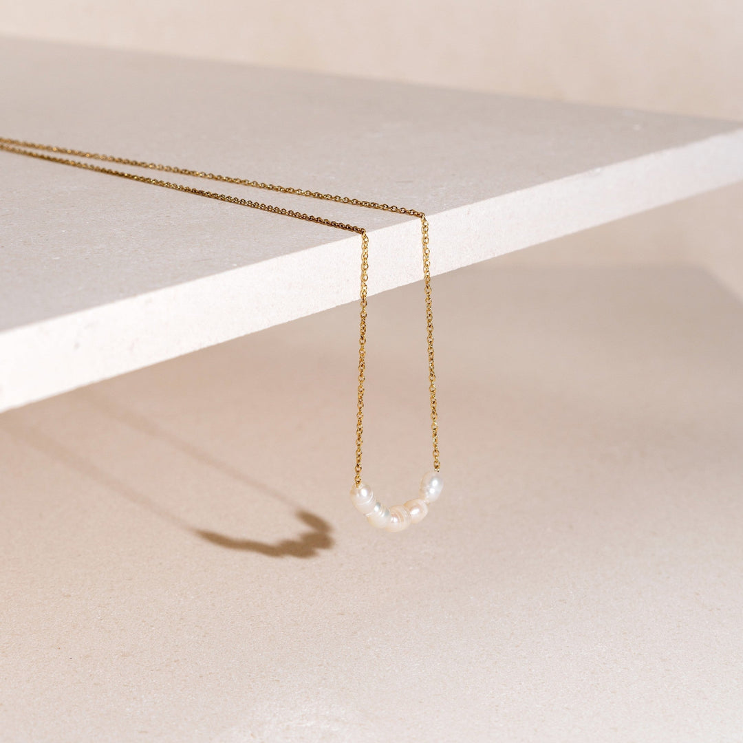 Gold plated delicate necklace with lustrous freshwater pearls, perfect for women.