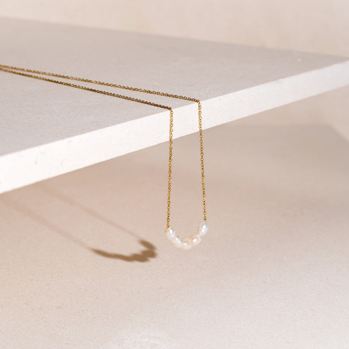 Gold plated delicate necklace with lustrous freshwater pearls, perfect for women.