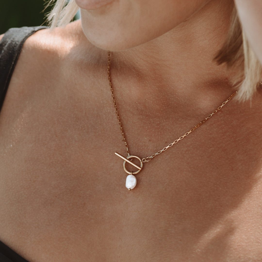 Close-up of lustrous freshwater pearls on an elegant women's necklace. Features a beautiful secure clasp.