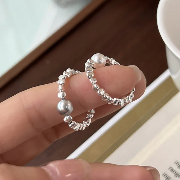 Adjustable women's wrap ring with a luminous pearl, sterling silver celestial galaxy design. Elegant fashion accessory.