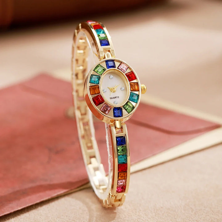 Silver women's gemstone bracelet watch, chic fashion accessory with an oval dial.