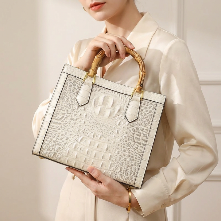 Stylish crocodile-pattern genuine leather purse for women, featuring a chic bamboo handle.