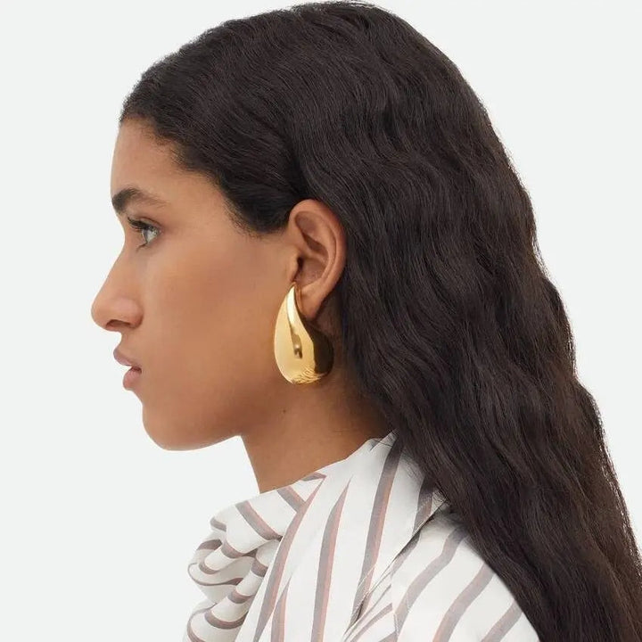 Elegant women's GlimmerDrop dangle earrings, sparkling droplet design. Fashion jewelry accessory.
