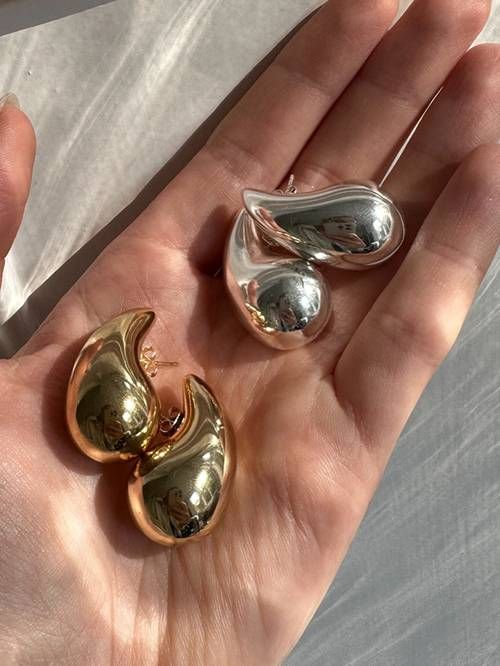 Close-up of elegant GlimmerDrop dangle earrings, showcasing the sparkling droplet and craftsmanship.