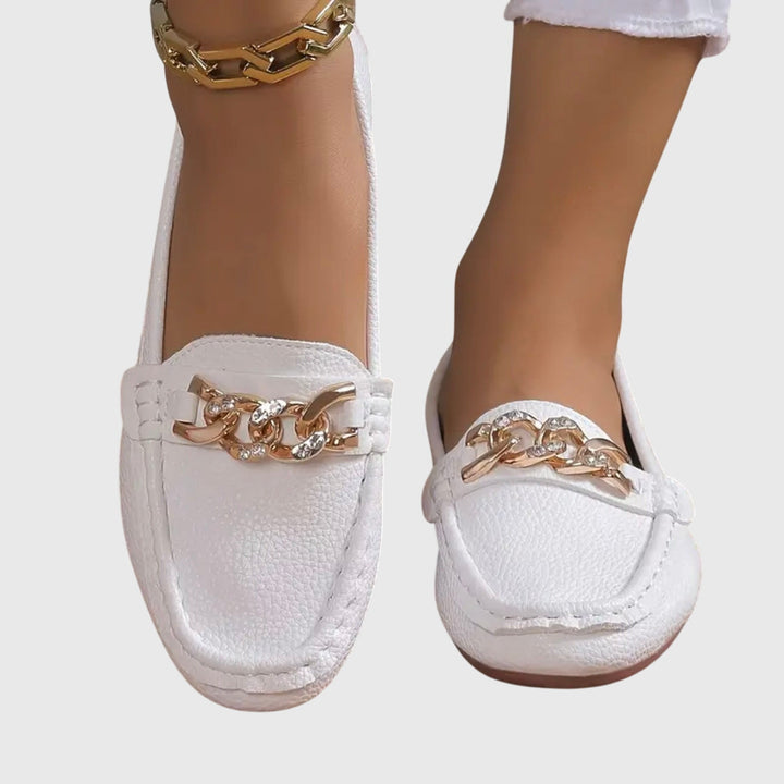 Chic women's wedge loafers with a comfortable heel and elegant gold chain, slip-on design.